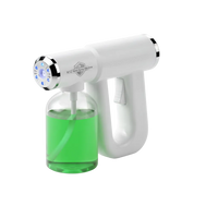 A handheld electric liquid dispenser with a white body, silver trim, and a clear bottle filled with bright green liquid, shown on a clean white background.